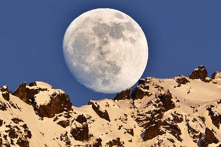24 hours: Silvaplana, Switzerland: The moon rises over the Piz Rosatsch Mountain