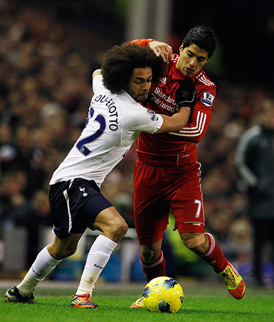 Liverpool v Spurs: Liverpool's Suarez challenges Tottenham Hotspur's Assou-Ekotto