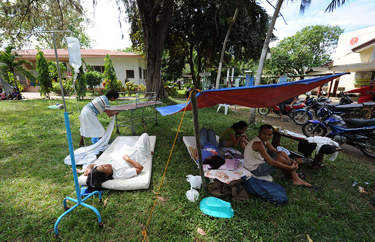 Philippines earthquake: Patients rest under the trees outside a hospital building 