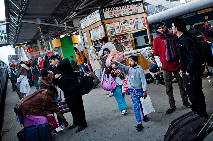 24 hours in pictures: New Delhi, India: A boy points towards a train carriage