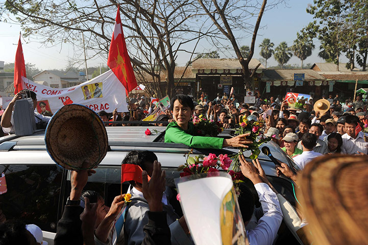 Aung San Suu Kyi campaign: Aung San Suu Kyi is surrounded by a crowd of supporters