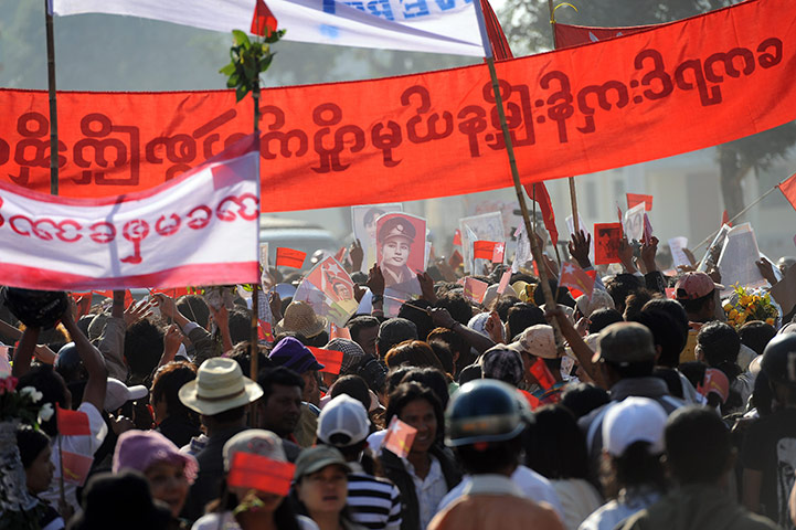 Aung San Suu Kyi campaign: Supporters wave a picture of Aung San Suu Kyi's father General Aung San
