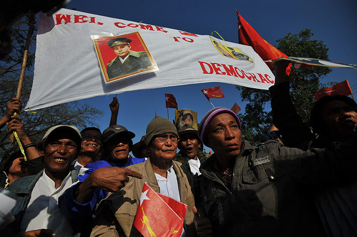 Aung San Suu Kyi campaign: Supporters greet Aung San Suu Kyi on her way to a political rally
