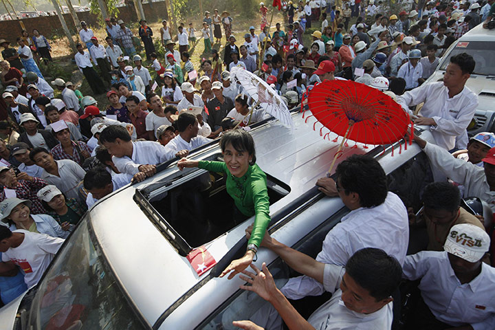 Aung San Suu Kyi campaign: Aung San Suu Kyi greets supporters from  her vehicle after her speech