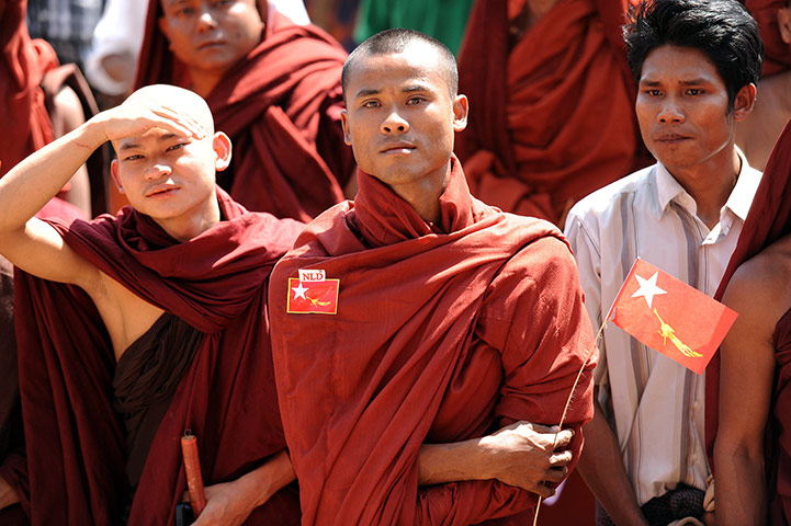 Aung San Suu Kyi campaign: Buddhist monks listen to a speech at a political rally in Pathein