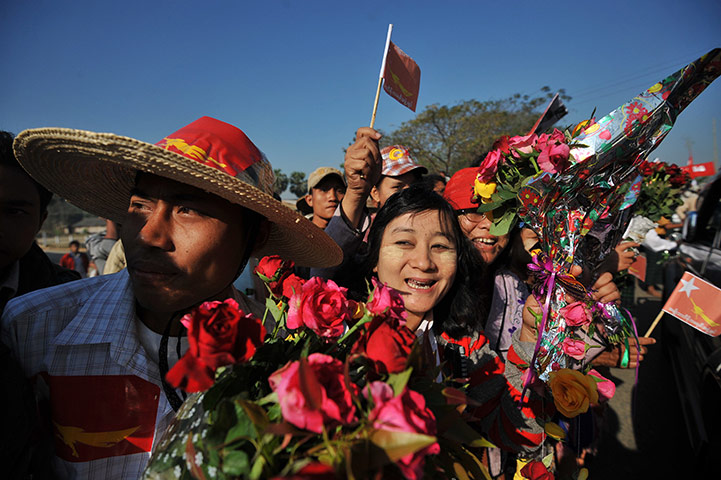 Aung San Suu Kyi campaign: Supporters greet San Suu Kyi on her way to a political rally