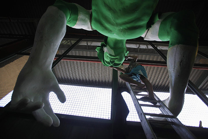 24 hours in pictures: A worker prepares a carnival float at Uniao da Ilha Samba School