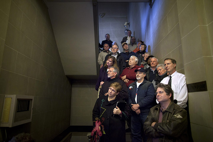24 hours in pictures: People listen in a stairwell to Newt Gingrich, Ohio
