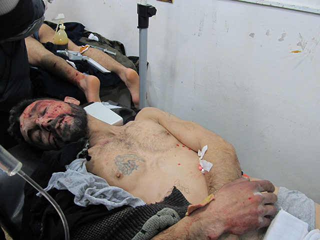 Syria clashes: A wounded man is seen in the Sunni Muslim district of Bab Amro in Homs