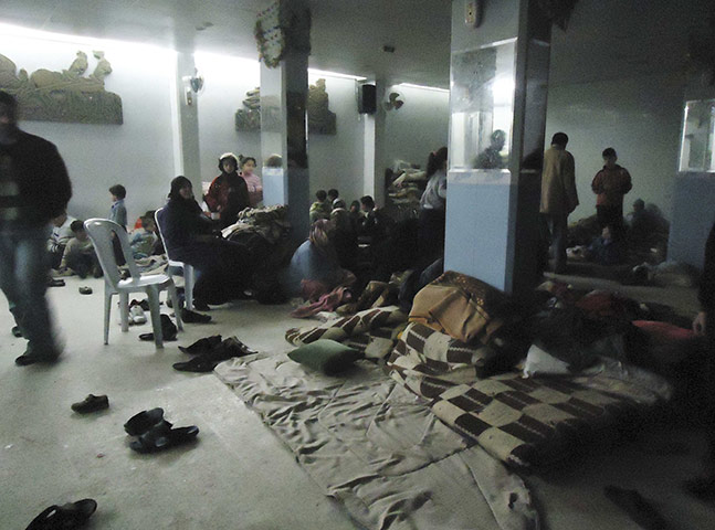 Syria clashes: Residents rest in a shelter in Baba Amro near Homs