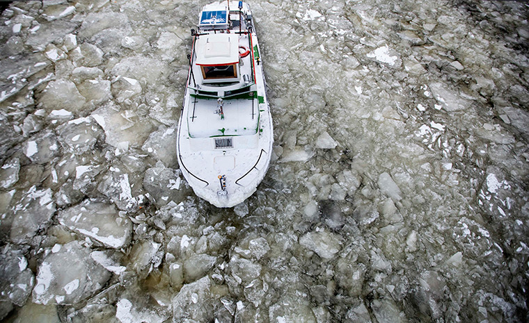 24 hours in pictures: Berlin, Germany: An icebreaker makes its way through floating ice sheets