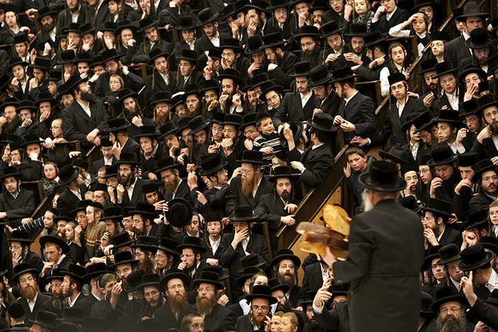 24 hours in pictures: Jerusalem: An Ultra-Orthodox Jewish rabbi distributes bread