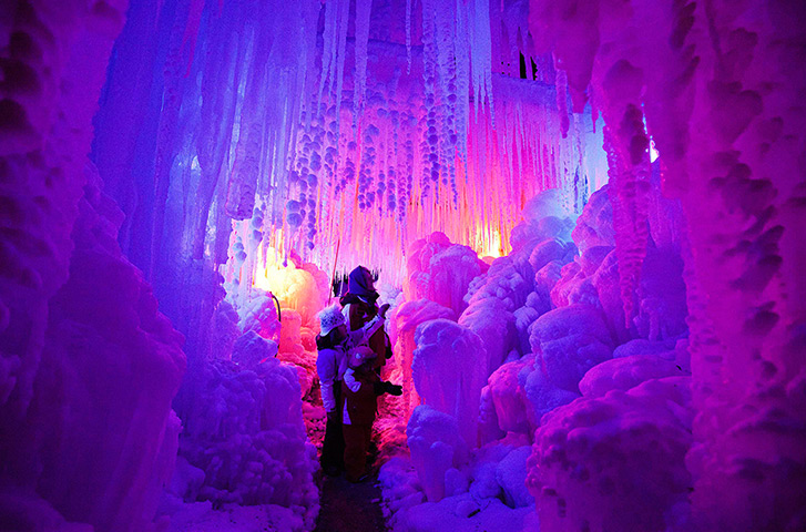 24 hours in pictures: Schwarzsee, Switzerland: Visitors walk through an illuminated 'ice palace'