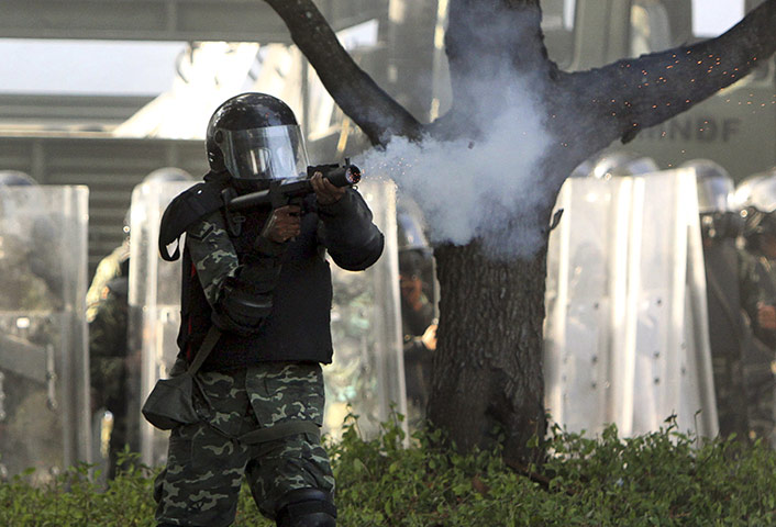 Maldives unrest: A soldier fires a rubber bullet towards police during a clash between them 