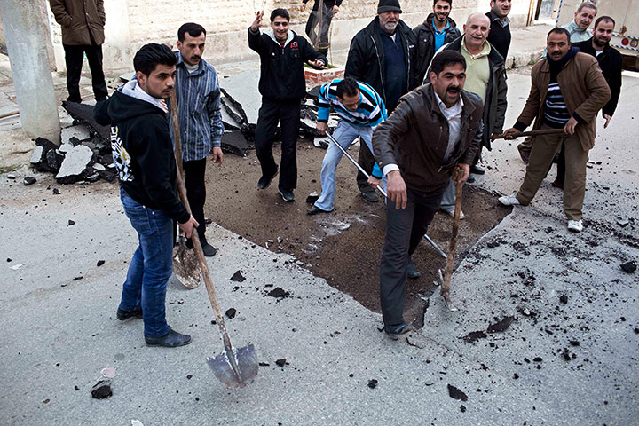 Syria Annan: People remove a speed bump to allow ambulances to drive faster in Idlib