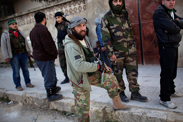 Syria Annan: Free Syrian Army fighters gather during fighting against government troops