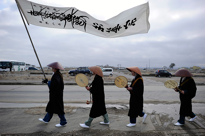 Japan anniversary: Buddhist monks sing prayers as they walk through Yuriage district