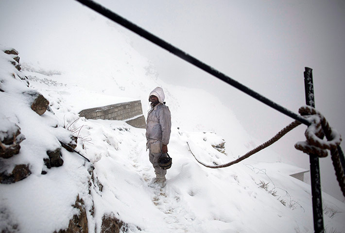 Featured Photojournalist: A soldier makes his way to his position atop the mountain near Kalpani base