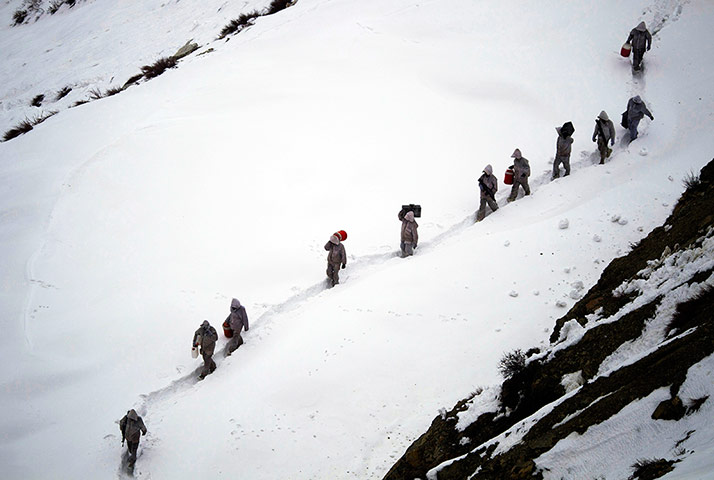 Featured Photojournalist: Soldiers carry supplies up the mountain to the Kalpani base