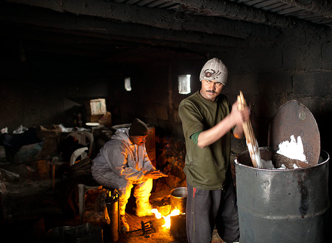 Featured Photojournalist: A soldier melts snow for drinking water at the Kalpani base