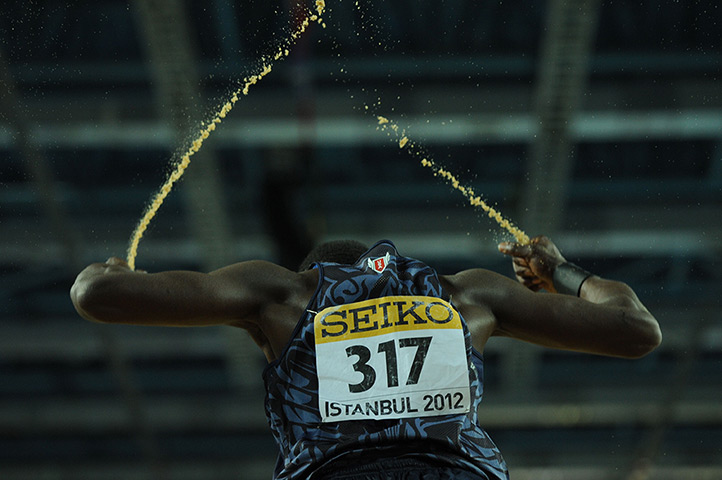 24 hours: Istanbul, Turkey: Will Claye reacts with handfulls of sand after a jump