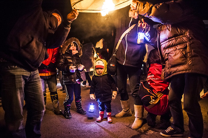 Japan tsumani: Families light paper lanterns in Natori