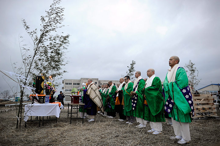 Japan tsumani: Buddhist monks offer prayers at the Yuriage junior high school 