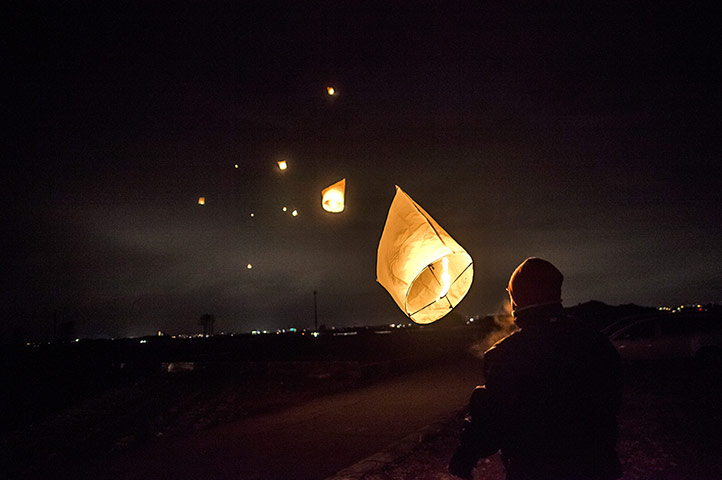 Japan tsumani: A man watches as his paper lantern floats away into the distance in Natori