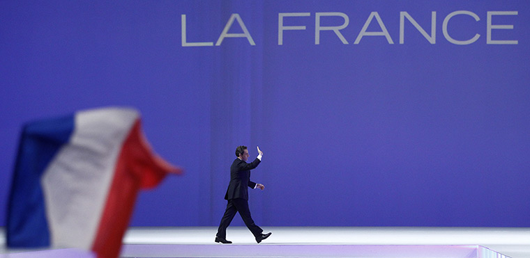 Sarkozy rally: Nicolas Sarkozy waves as he arrives on stage to deliver a speech 