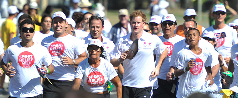 Prince Harry on tour: Prince Harry holds a mask as he runs a Sport Relief Mile in Rio de Janeiro