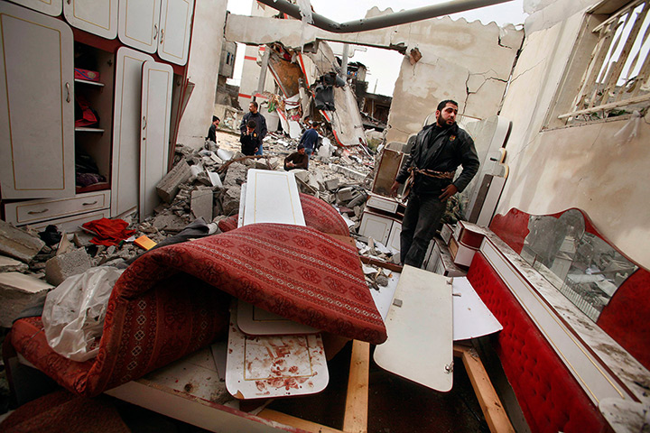24 hours in pictures: a Palestinian man surveys a destroyed house