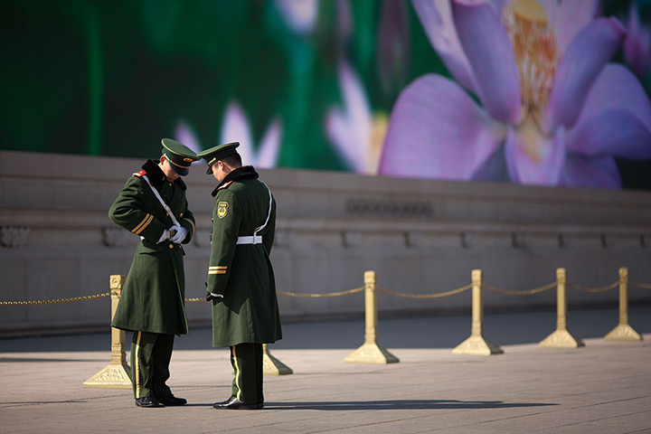 24 hours in pictures: paramilitary policemen change guard in Tiananmen square