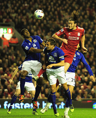Liverpool v Everton: Liverpool's Andy Carroll out jumps the Everton defence 
