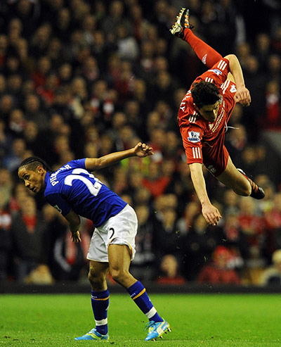 Liverpool v Everton: Martin Kelly goes flying as he challenges Steven Pienaar 