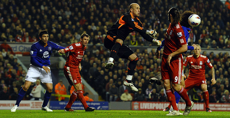 Liverpool v Everton: Jose Reina snuffs out an Everton attack with the aid of a hefty punch clear
