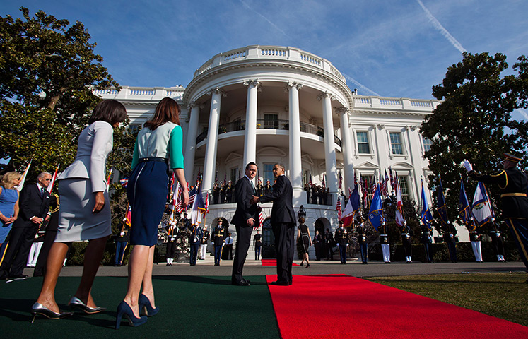 Cameron in US: Barack Obama and David Cameron wait for their wives on the South Lawn