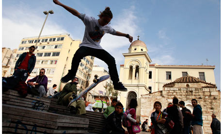 A Greek youth performs skateboard tricks in Athens