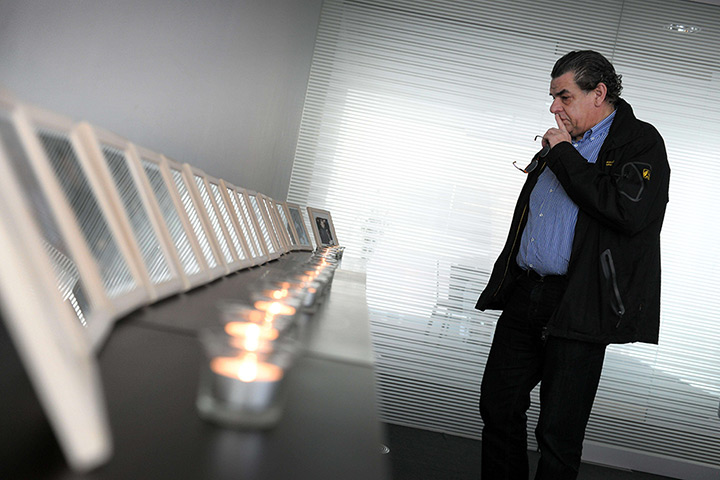 24 hours: Lommel, Belgium: A man looks at pictures of victims of the Swiss bus crash