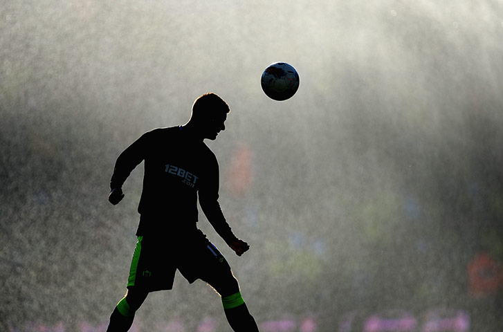 Best of the week: Wigan's Callum McManaman warms up ahead of the game against Norwich 