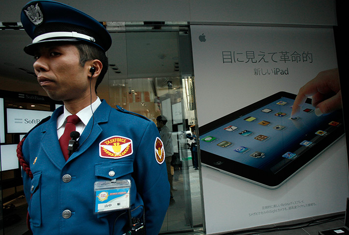 New iPad goes on sale: Tokyo, Japan: A security guard stands in front of an Apple Store