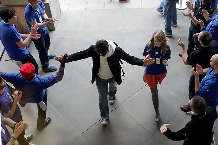 The new iPad: A shopper is welcomed into the Apple Store by staff in Covent Garden