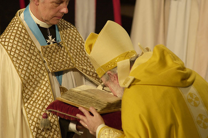 Dr Rowan Williams: The Archbishop of Canterbury kisses the Canterbury Gospels 