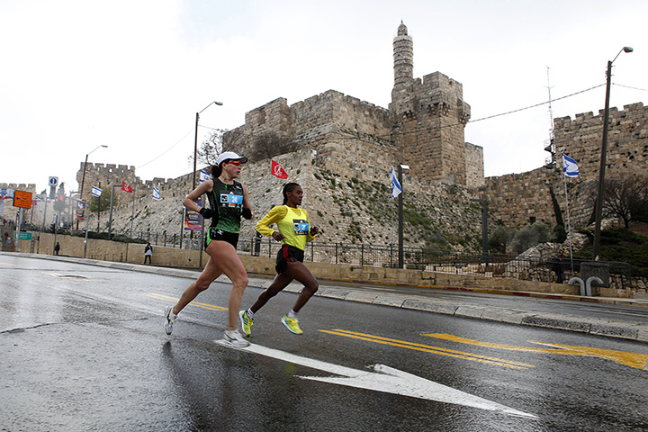 Jerusalem Marathon: Marathon runners pass the Jaffa Gate with the Tower of David 