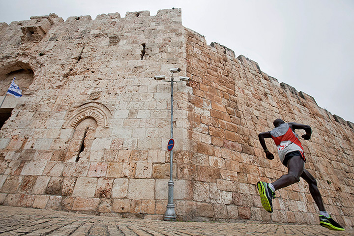 Jerusalem Marathon: Runner comes through the Zion Gate and runs down past the Old City walls