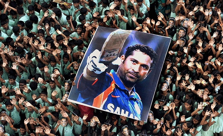24 hours: Students hold a large poster of Indian cricketer Sachin Tendulkar