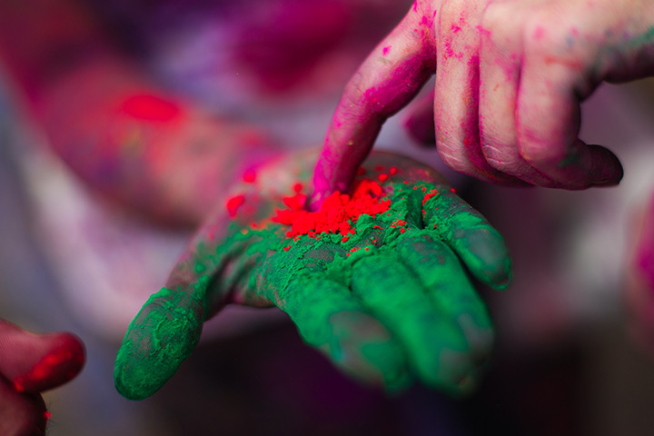 24 hours in pictures: Indian devotee displays coloured powder during 'Holi' in Kuala Lumpur