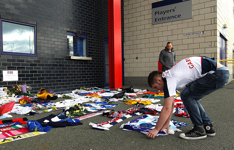 Muamba get well messages: A Bolton Wanderers supporter lays a message outside the Reebok Stadium