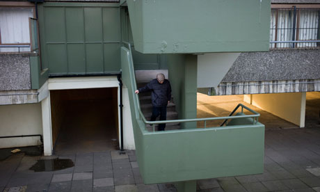 An elderly man walks down a stairwell