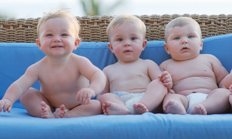 Four toddlers wearing nappies