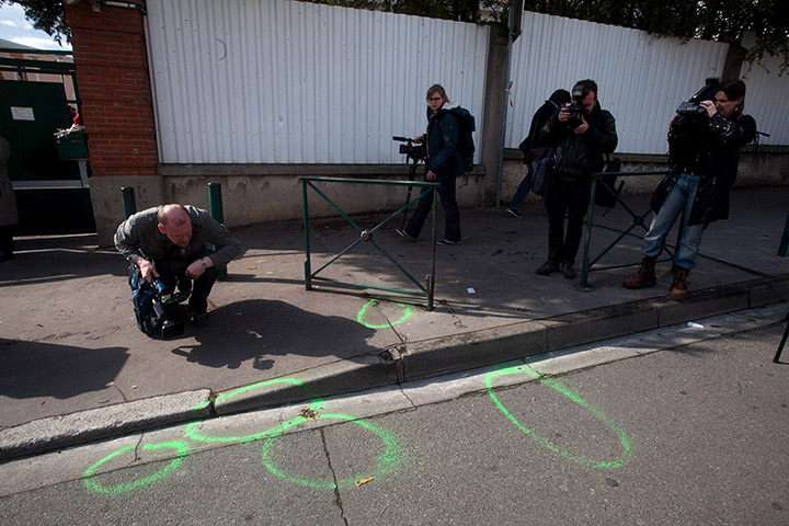 Toulouse shooting: Members of the media look at and document marking